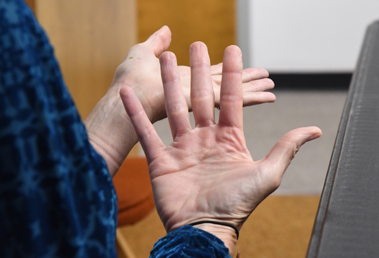 Cindy A. gestures while talking about teaching yoga.