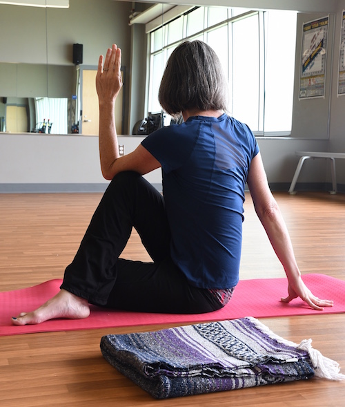 Cindy A. demonstrates one of the yoga positions she uses in her 12-step yoga class at the Trinity Community Center.