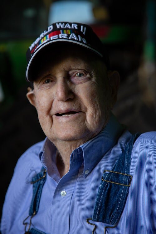 Ernest still farms and drives his pickup truck with his ever-faithful companion, a dog named Tiny, by his side.