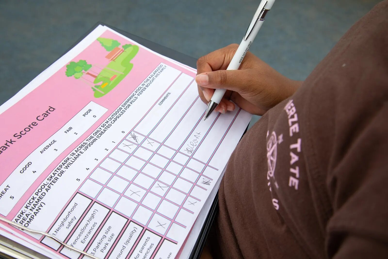 The Merze Tate Explorers filled in grids for each park they visited to generate a score for each one. A Merze Tate Explorer reporter fills out a park grade/scorecard.