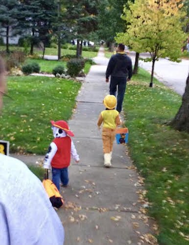 Don Solesbee leads his son Luca, in yellow, and another child in trick-or-treating in 2016.