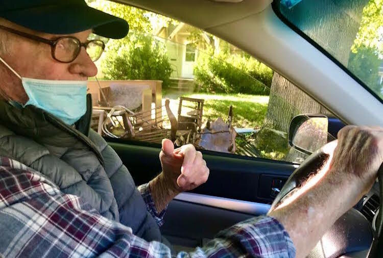 John Hilliard, president of the Milwood Neighborhood watch Association, is shown patrolling the huge neighborhood in his car in September of 2020.