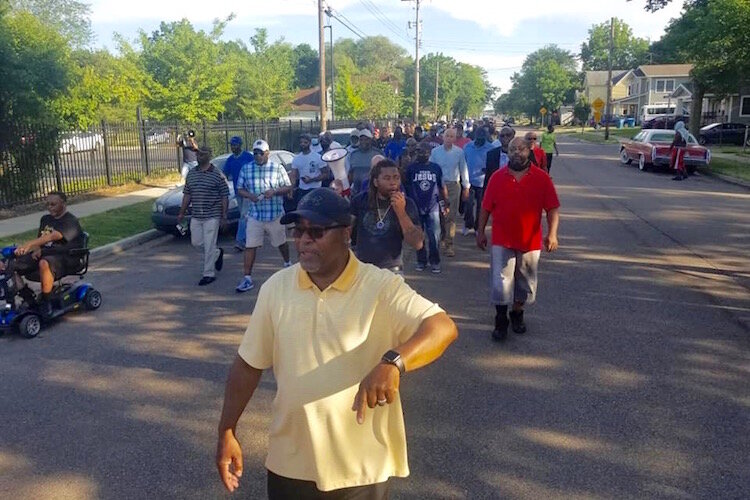 Men marched Tuesday evening, June 8, through Kalamazoo’s Northside neighborhood to call attention to the need for community members to stand against gun violence.