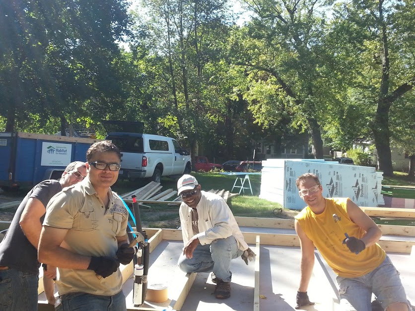The Habitat for Humanity crew with Ben Brown, center, pause while building Brown's tiny house.