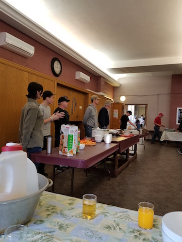 Volunteers stand ready to serve breakfast.