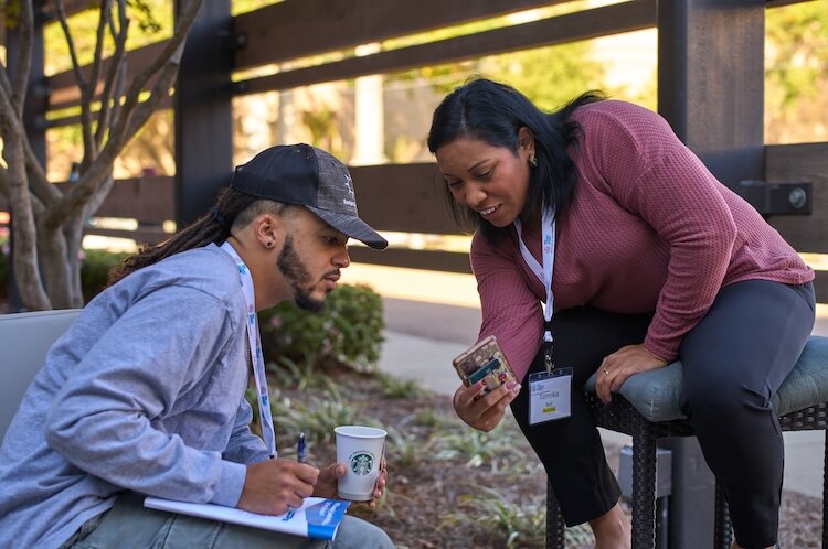 Devon Wilson sits with Tomika Bell, a local food coordinator at Choctaw Fresh Produce on the Choctaw Nation in Mississippi.