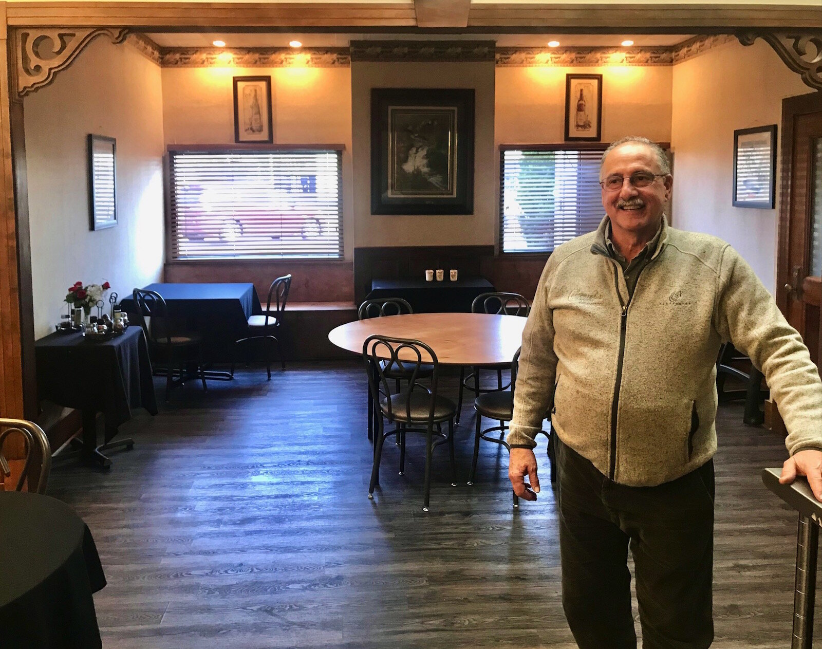 Peter Comensoli stands in a dining and private events room that helped the restaurant space out its customers in order to meet state-mandated social distancing requirements.