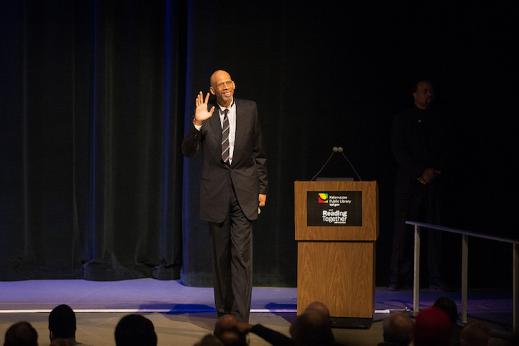 Kareem Abdul-Jabbar says hello to the full house at WMU's Miller Auditorum for the Kalaamazoo Public Library's Reading Together discussion