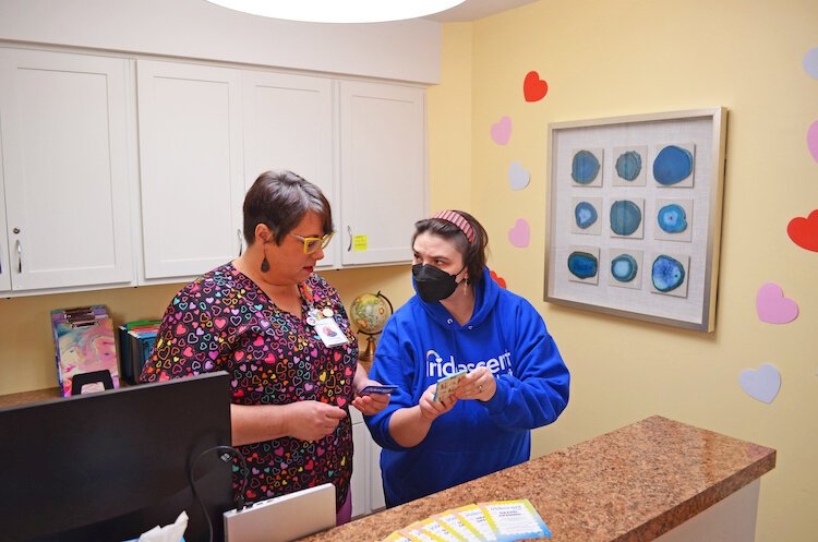 Love Chambers and Clinical Care Coordinator Christine Babcock in the reception area of Iridescent Health.