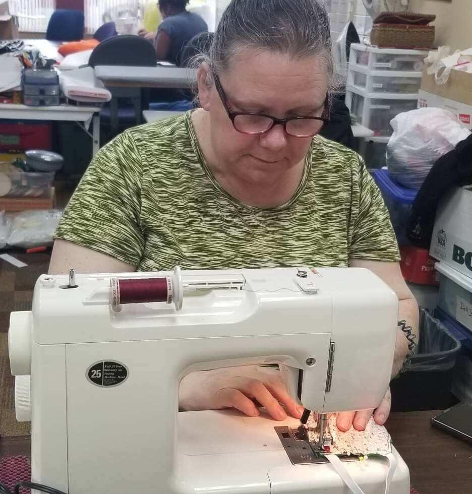Tammy Jimenez, a staff member with Charitable Union, sews a mask which is one of more than 1,000 made and donated to first responders and organizations, including Care Well Services.