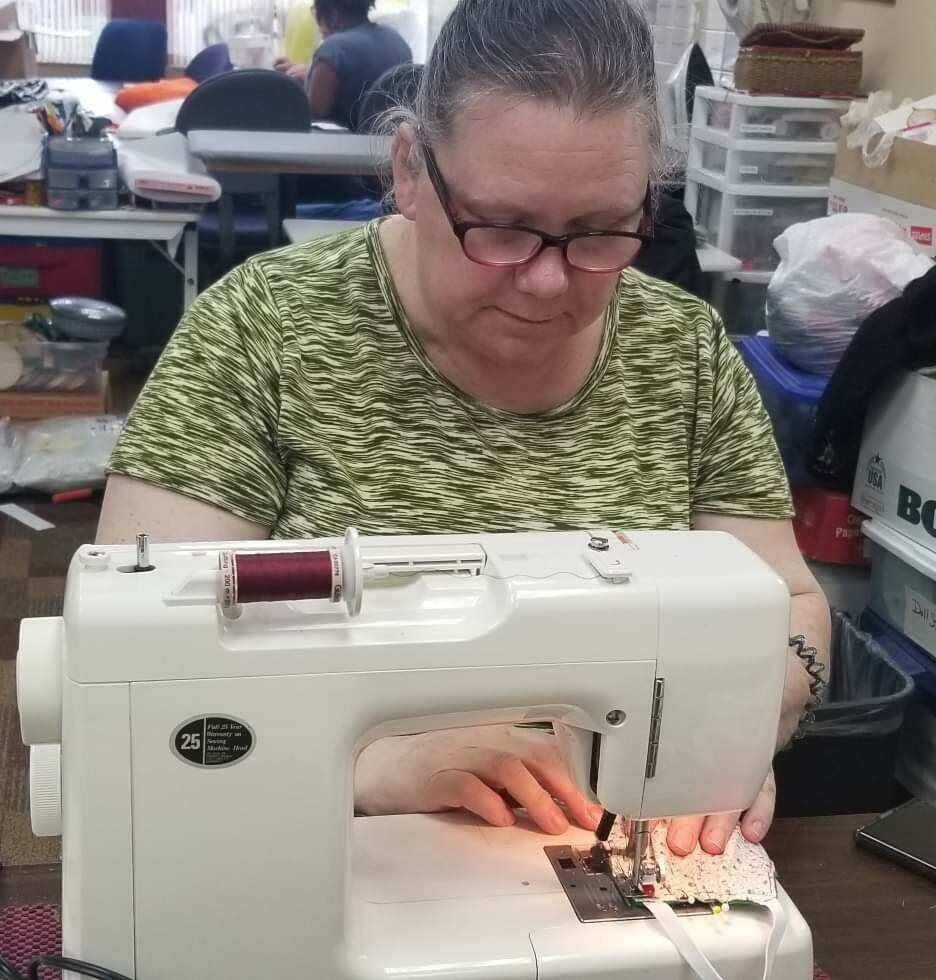 Tammy Jimenez, a staff member with Charitable Union, sews a mask which is one of more than 1,000 made and donated to first responders and organizations, including Care Well Services.