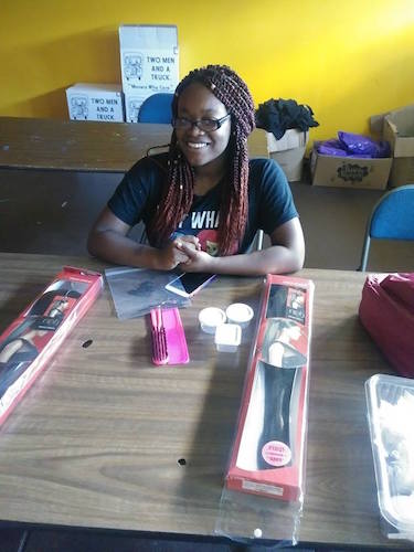 A young woman at the Teen Hair Clinic offered by Young Kings and Queens