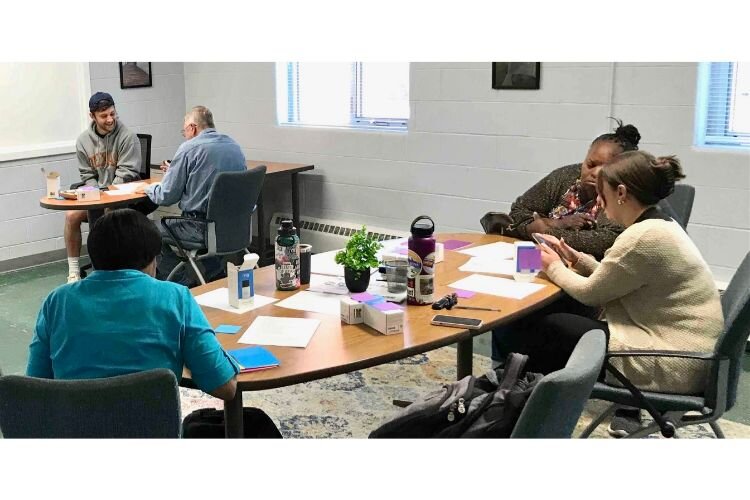 Learning to link their smartphones and other devices to doorbell camera systems was a key to making the security initiative successful, particularly for older area residents who are not tech-savvy. WMU students are shown helping area residents.