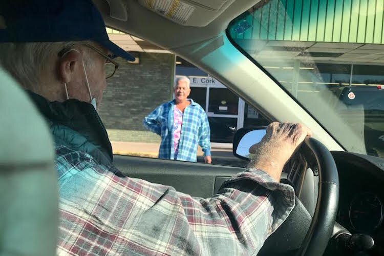 John Hilliard, president of the Milwood Neighborhood Watch Association, talks with a business owner during one of his recent patrols of the neighborhood. Hilliard checks for vandalism, graffiti and other problems that concern residents and businesses