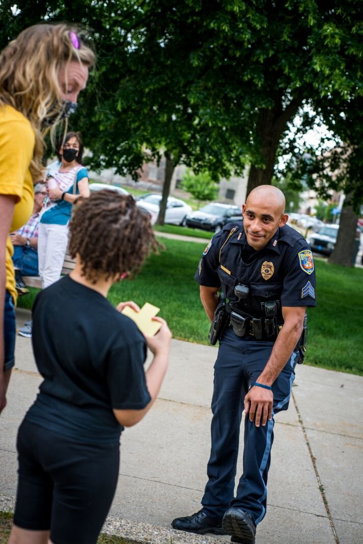 A Kalamazoo Department of Public Safety Officer greets those gathered to observe George Floyd's death.
