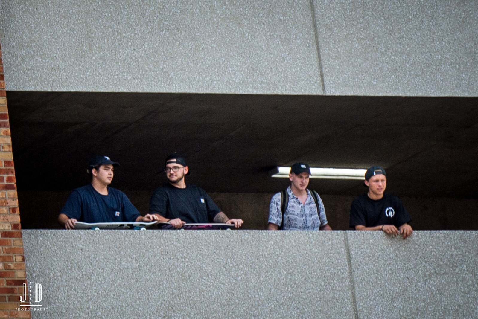 Proud Boys look out from the safety of the Raddison Parking ramp.