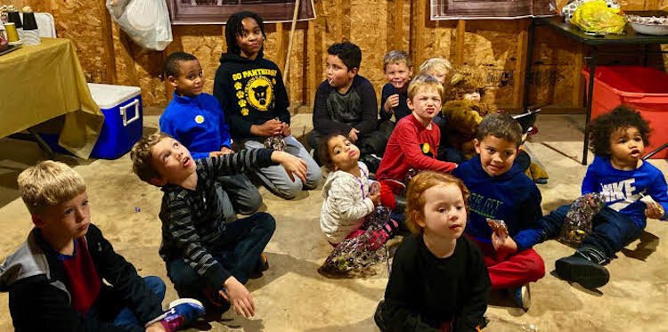 Youngsters in the 1400 block of Reycraft Drive, including Solesbee’s son Luca, bottom left, gather for a Halloween party last year in the garage of Lauren Pott Hernandez and her family.