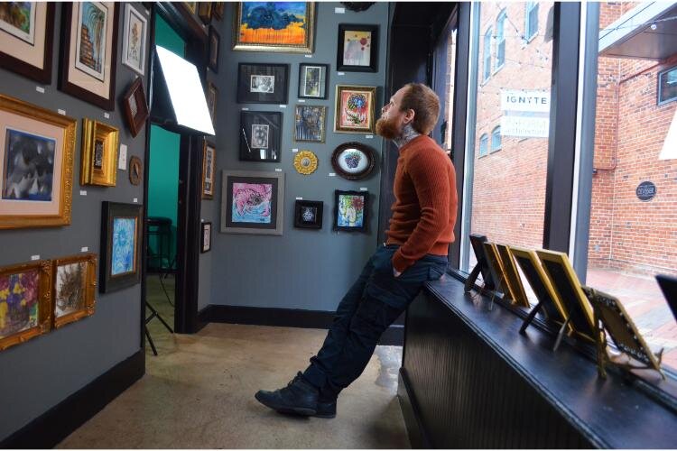 Artist and owner Trevor Jackson inside of the Hobbit Hole Gallery. 