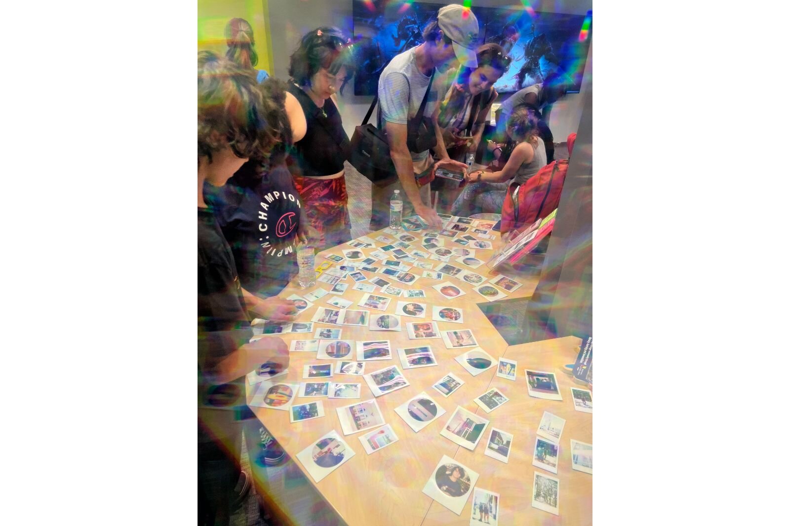 Several students view their printed photographs at the Kalamazoo Public Library, in the teen area. 