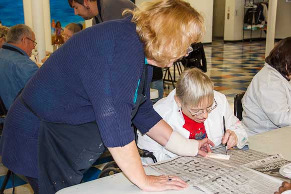 Penny LaFrance assists Nancy Majesky with painting