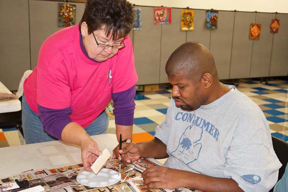 Kathy Keller helps Danny Mansker with ornament painting