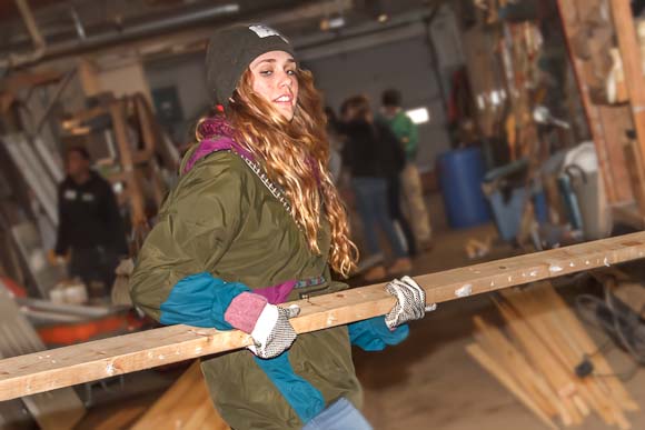 Volunteer Mia Orlando moves lumber