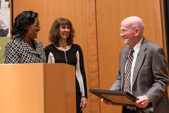 Belinda Tate and School Director Denise Lisiecki make presention to Kirk Newman