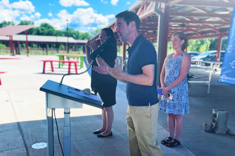 State Sen. Sean McCann speaks at the 2022 ADA Celebration, with state Rep. Julie Rogers and an ASL interpreter standing by.