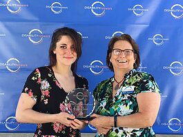 Alexx Smith, recipient of the 2022 Bob Davis Independent Living Award, stands with Disability Network Southwest Michigan staff member Mary Fortney.