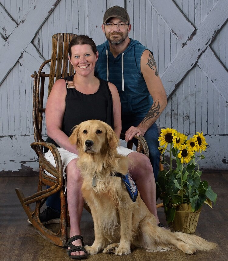 Candace Carlisle with her husband and service dog, Denali. (Courtesy)