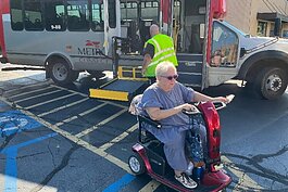 Sharon DeHaan gets off at an accessible bus stop