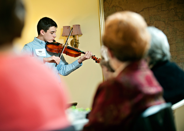 Nathan Micklatcher, of the Music Center of Battle Creek, performs at a recent meeting of Women Who Care. The group gives money to many arts  related groups in the area. 