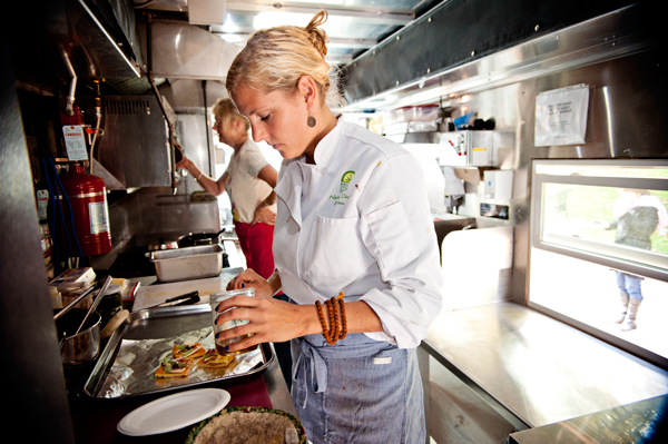 Bridgett Blough prepares Tomato Pesto sandwiches. All of her ingrediants are made from locally grown sources.