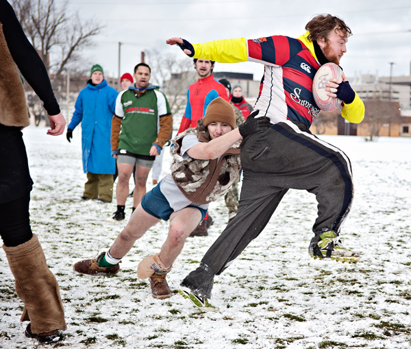 A Snowball Rugby Tournament player escapes the grasp of an opponent.