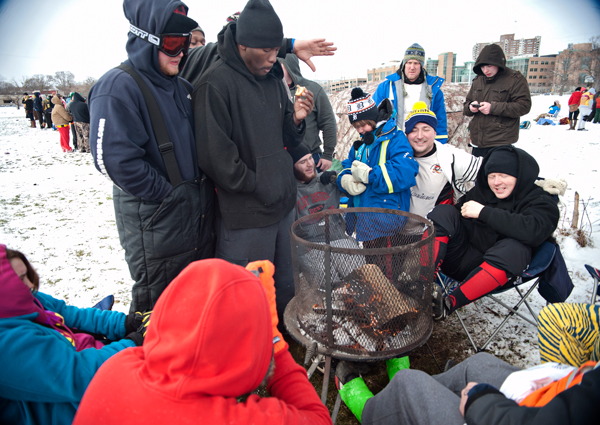 Participants of the Snowball Rugby Tournament gather to stay warm.