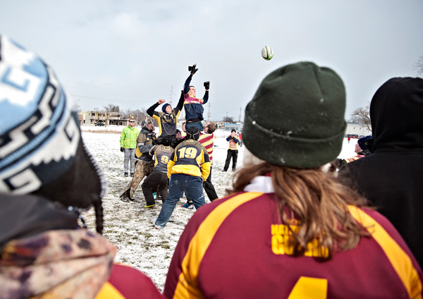 The Western Michigan and Central Michigan teams leap for possession of the ball 