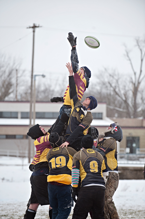 Competing teams leap after the ball during the Snowball Rugby Tournament. 