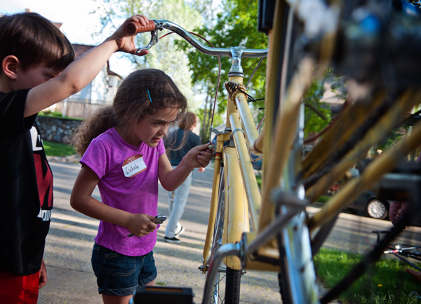 Isabella Santos-Pye, 6, tightens a screw on a bike she is helping to fix up at Open Roads in the Edison neighborhood. 