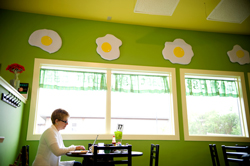 Jill Hess finishes up some work during her breakfast at Egg East in Portage, MI / Erik Holladay