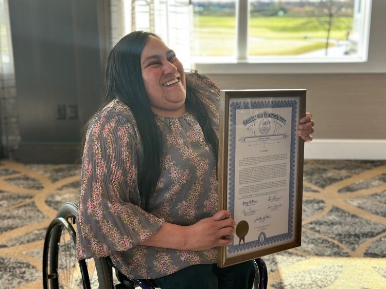 Lucia Rios holds State of Michigan Special Tribute signed by Gov. Gretchen Whitmer and other state officials. (Shandra Martinez)