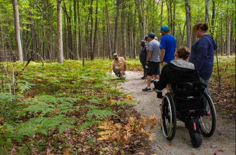 Jeffrey VanDyke, who uses a wheelchair, explores an accessible trail in the Anderson Woods Nature Preserve.