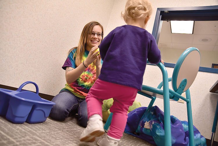 Danielle Mott, an intern at the CTAC in 2016, works with a young child during a child trauma assessment.