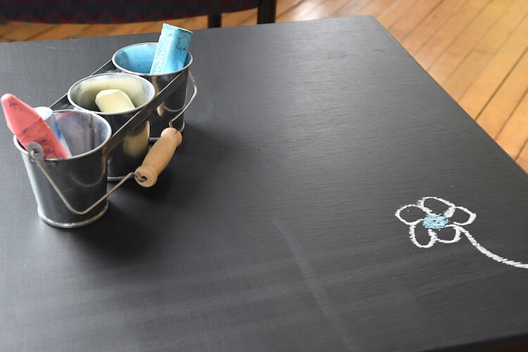 There is a small table with blackboard paint and chalk in A2A’s meeting space.