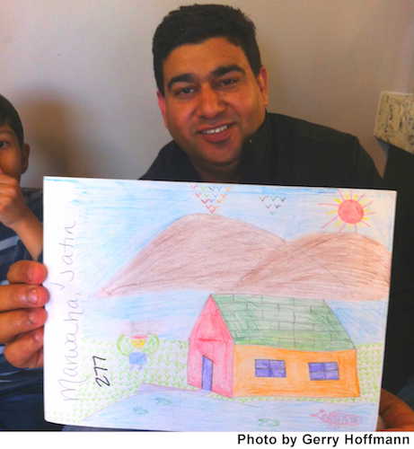 Amit Kumar proudly showed off his son's artwork during the Dental Day of Caring.