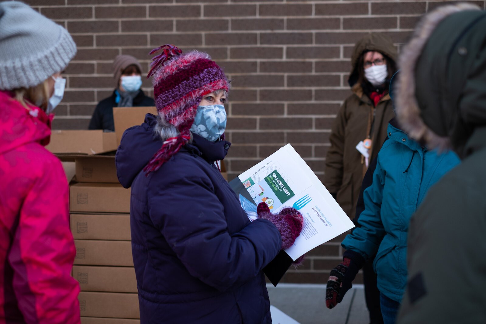 Amy Dandenault helps distribute boxes of fresh food to those participating in the Fresh Food Pharmacy program.