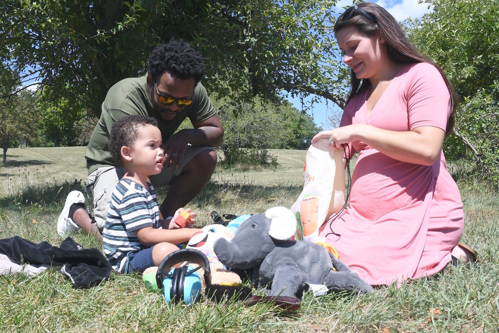 Audrina Hampton reaches into a bag for some sensory toys for her son Greyson, who is on the autism spectrum. Her husband Byron is also seen in the photo.