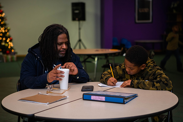 Jeff Cotton works with a youngster at New Level Sports Ministry.