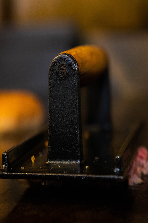 A hamburger sizzles on the grill at Speed's.