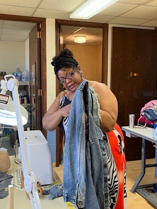 Ayanna Williams embroiders a denim jacket in the Co-op's sewing room.