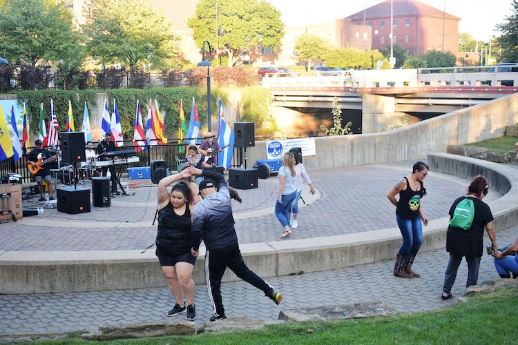 A couple dances to the music of  La Celestina y los Sanchez, a local cumbia band based in Battle Creek, during an outdoor gathering on September 25 at Friendship Park to celebrate Hispanic heritage Month.